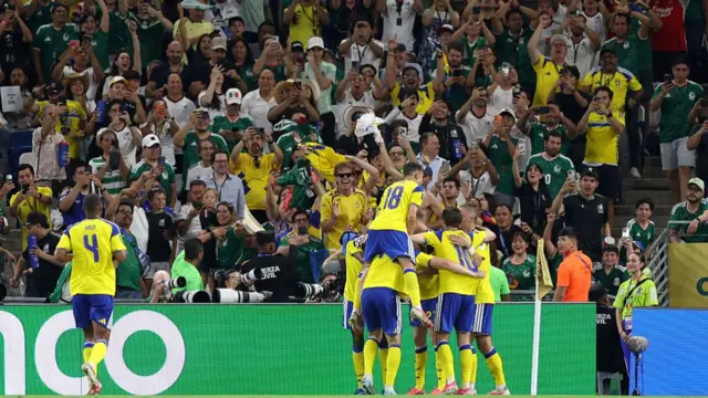 Sweden players celebrate scoring