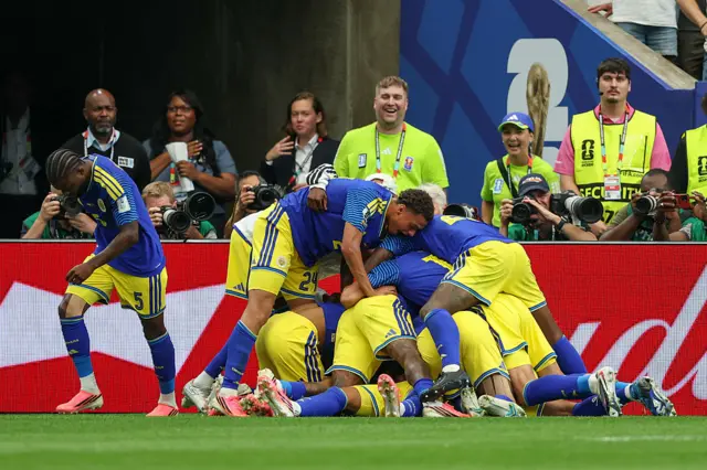 Curacao players pile on each other in celebration