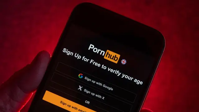 A screen which shows the Pornhub website with a note that says 'Sign up for free to verify your age'