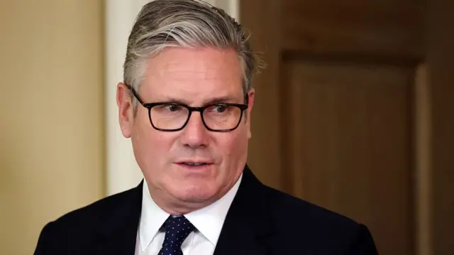 close-up of Keir Starmer, wearing glasses and a suit and tie