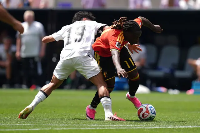 Jeremy Doku in action against Ahmed Fatouh