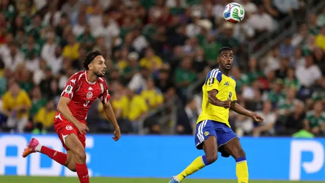Montassar Talbi and Alexander Isak fight for the ball