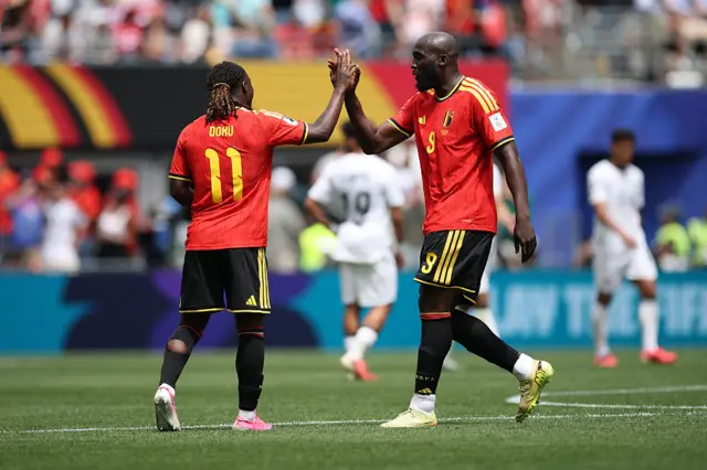 Romelu Lukaku celebrates with Jeremy Doku