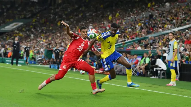 : Alexander Isak and Yan Valery compete for the ball