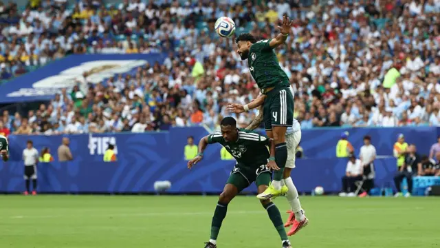 Saudi Arabia defender Abdulelah al-Amri heads the ball clear