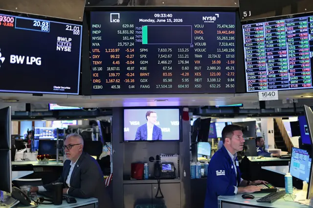 Traders work on the floor of the New York Stock Exchange during morning trading on June 15, 2026 in New York City.