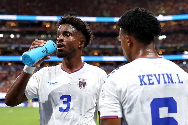 Diney Borges #3 and Kevin Pina #6 of Cabo Verde take a drink during a hydration break