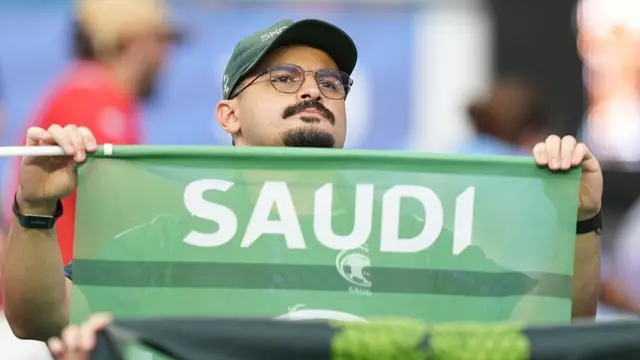A Saudi Arabia fan holding a flag