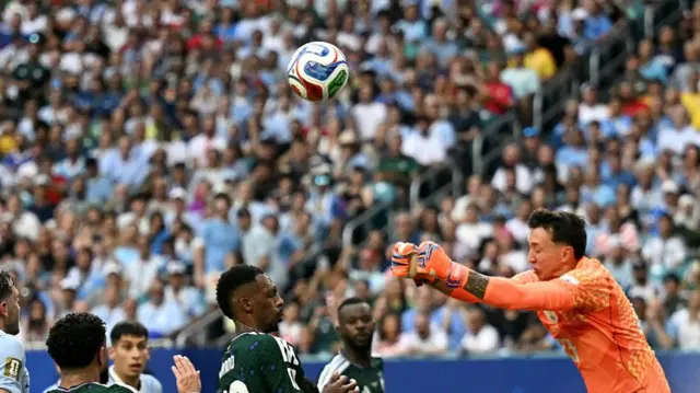 Fernando Muslera of Uruguay punches to clear the ball