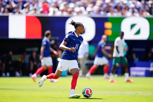 Michael Olise (11) of France drives the ball
