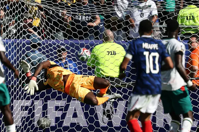 Senegal's goalkeeper #16 Edouard Mendy concedes France's third goal scored by forward #10 Kylian Mbappe
