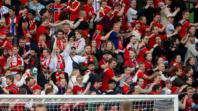 Fans of Norway gestures on the tribune during the international friendly match