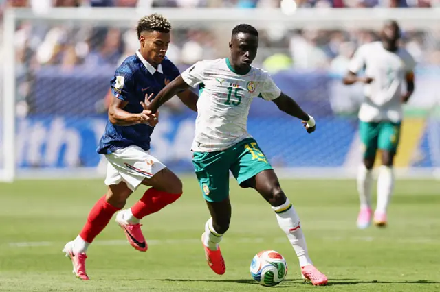 Desire Doue (L) and Senegal's defender Krepin Diatta fight for the ball