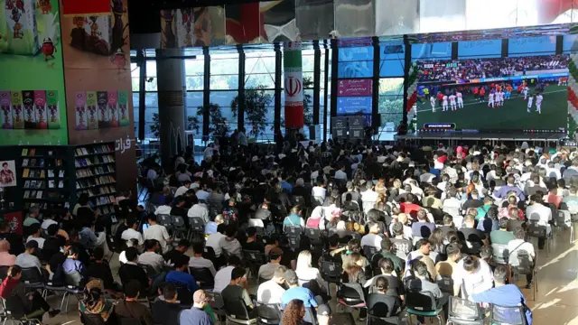 Iranian football fans gathered in large venues and cafes, including the popular 'Book Garden', watch their national team's opening match against New Zealand at the 2026 FIFA World Cup in Tehran, Iran, on June 16, 2026. Wearing national jerseys and waving flags, a large number of supporters filled the specially prepared platforms to follow the thrilling encounter with great passion, which eventually ended in a 2-2 draw.