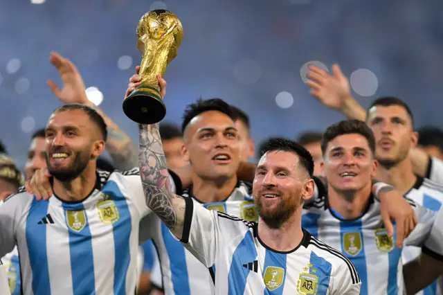 Lionel Messi holding the World Cup trophy