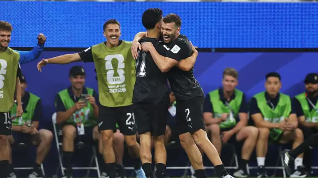 : Elijah Just celebrates with teammate Tim Payne after scoring his team's second goal