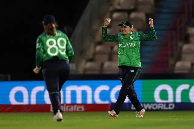 Gaby Lewis looks delighted with ball in hand, celebrating wicket.