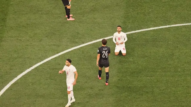 Iran and New Zealand players react at full-time