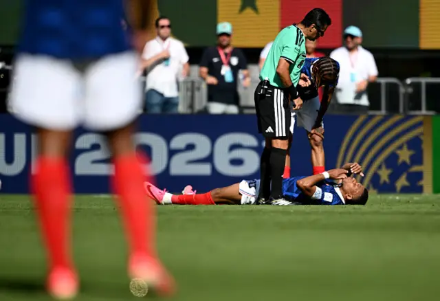 Kylian Mbappe of France is attended to by referee