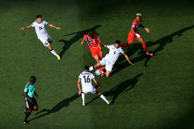 : Sander Berge #8 of Norway is challenged by Zaid Tahseen