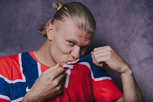 Erling Haaland kisses the Norway badge