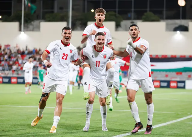 Jordan players celebrate scoring their team's goal against Turkmenistan