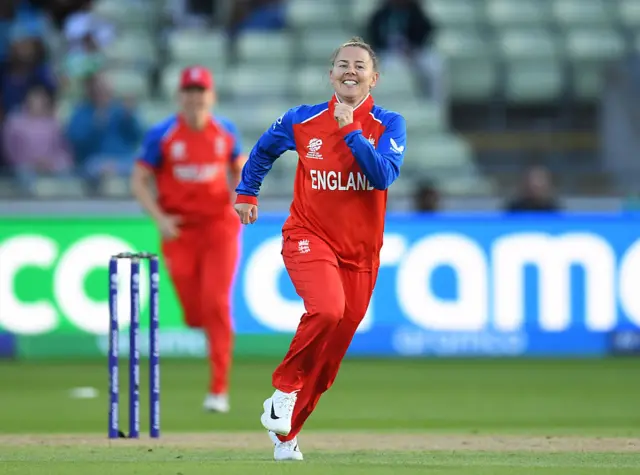 England's Linsey Smith, smiles and celebrates as she runs away from the wicket.
