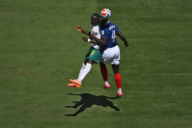 Sadio Mane (L) and France's defender #04 Dayot Upamecano fight for the ball
