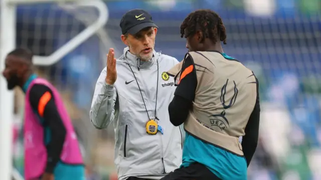 homas Tuchel, Manager of Chelsea speaks with Trevoh Chalobah of Chelsea during a Chelsea FC Training Session ahead of the UEFA Super Cup 2021 match between Chelsea FC and Villarreal at Windsor Park on August 10, 2021 in Belfast, Northern Ireland.