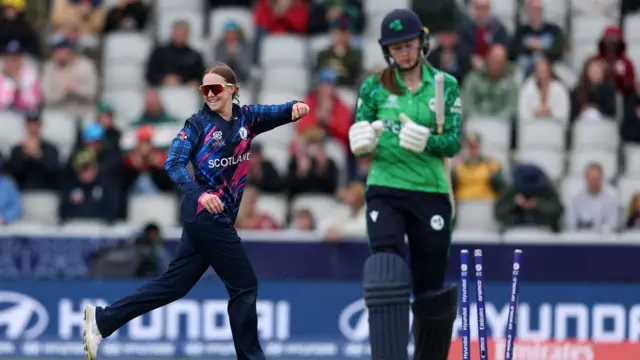 Kirstie Gordon celebrates after taking the wicket of Alice Tector