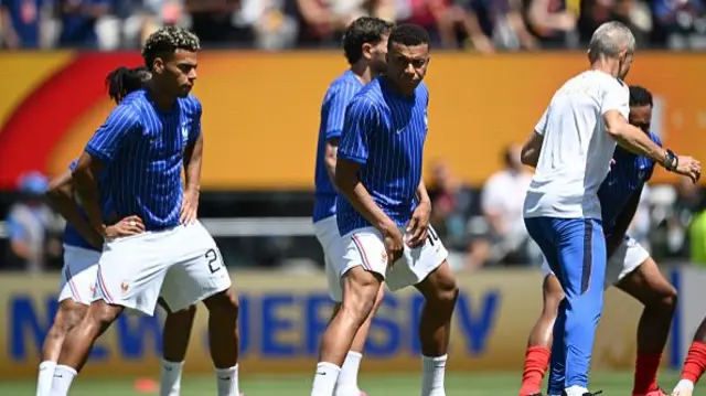 Desire Doue and Kylian Mbappe of France warm up