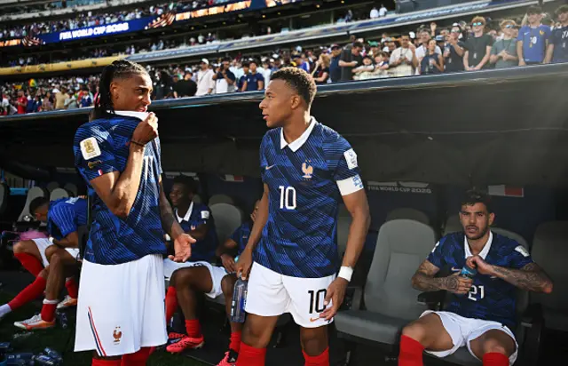 Michael Olise and Kylian Mbappe of France celebrate