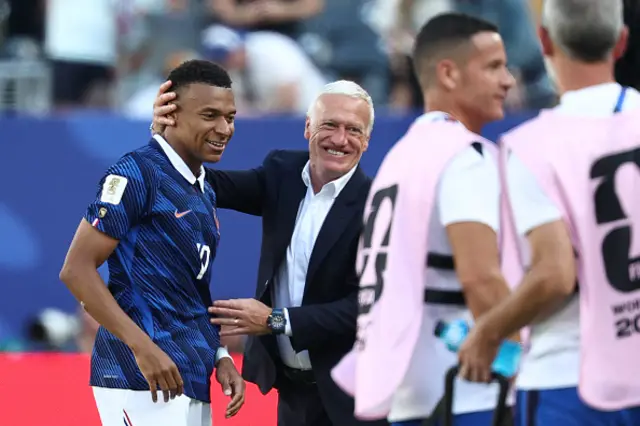 France's head coach Didier Deschamps congratulates his forward #10 Kylian Mbappe