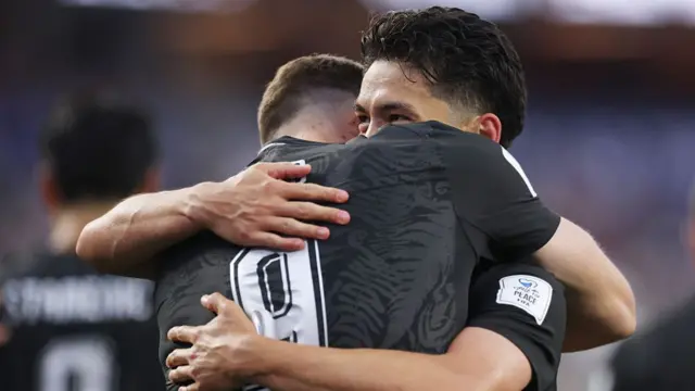 Elijah Just celebrates with teammate Chris Woo