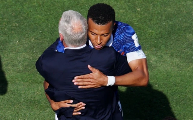 France's Kylian Mbappe celebrates scoring their first goal with coach Didier Deschamps