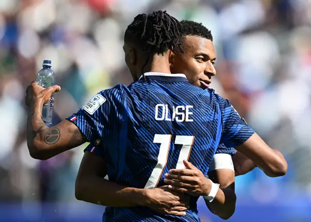 Kylian Mbappe of France celebrates with Michael Olise
