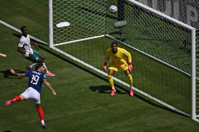 Theo Hernandez (R) and Senegal's goalkeeper #16 Edouard Mendy eye on the ball