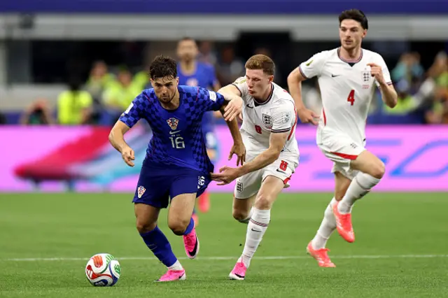 Martin Baturina of Croatia is challenged by Elliot Anderson