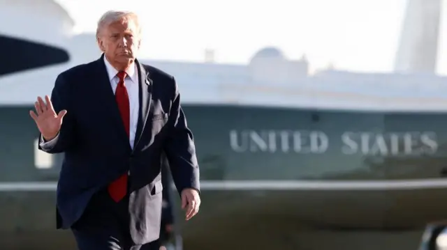 Donald Trump is pictured waving, with an aircraft in the background emblazoned with 'United States' livery.