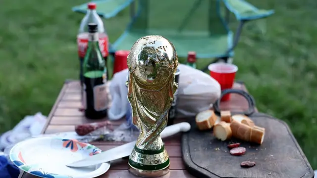 A replica World Cup sits upon a table used for a barbeque as Argentina supporters gather at Mill Creek Park on June 15, 2026 in Kansas City, Missouri.