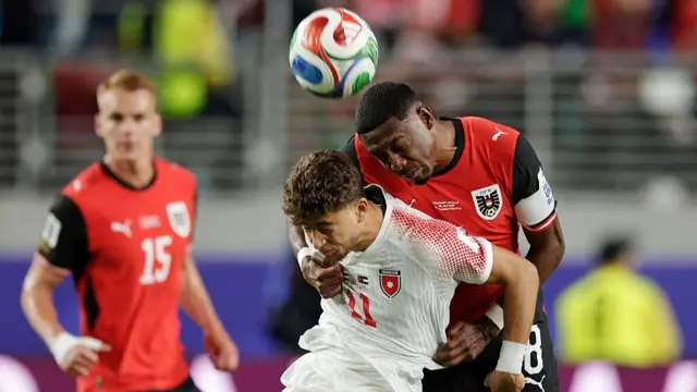 Odeh Al Fakhouri of Jordan and David Alaba of Austria compete for the ball