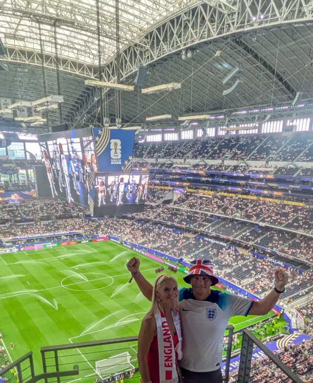 England fans pose for a photo high up in the stadium