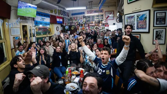 Argentina fans celebrate Lionel Messi's third goal during the FIFA World Cup 2026 Group J match between Argentina and Argelia at "Varela Varelita" Bar on June 16, 2026 in Buenos Aires, Argentina