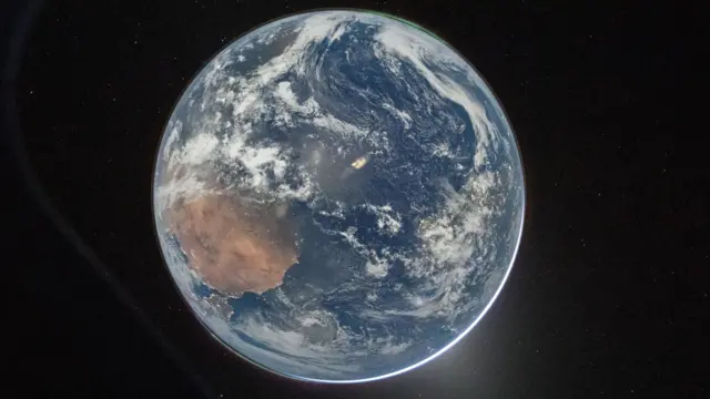 A handout picture made available by the National Aeronautics and Space Administration (NASA) shows NASA astronaut and Artemis II Commander Reid Wiseman's picture of Earth taken from the Orion spacecraft's window on April 2, 2026, after completing the translunar injection burn.