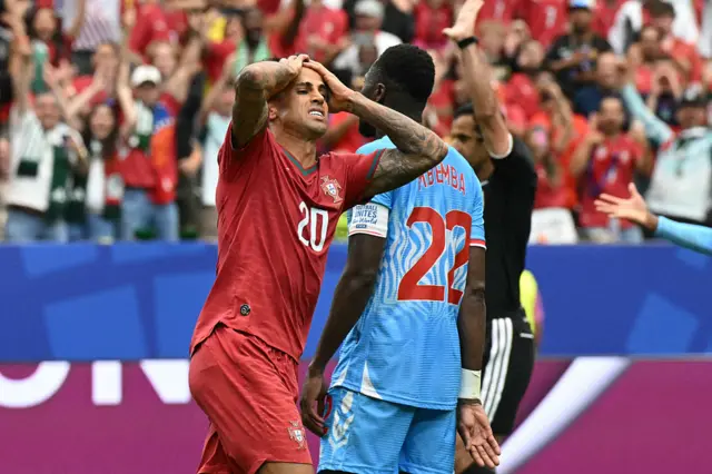 Portugal's defender #20 Joao Cancelo (L) reacts