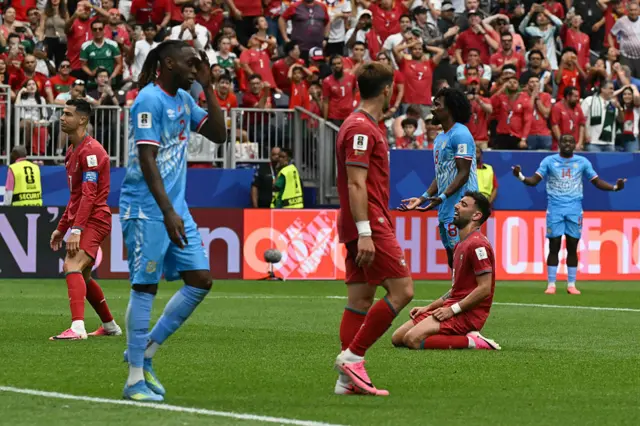 Portugal's midfielder #08 Bruno Fernandes (R) and Portugal's forward #07 Cristiano Ronaldo (L) react