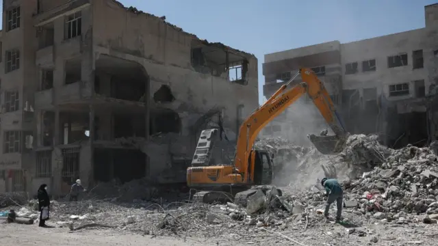 A machine operates near a residential building, which was damaged in a U.S. and Israeli strike in March, in Tehran, Iran June 7, 2026