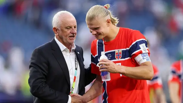 Erling Haaland #9 of Norway shakes hands with Graham Arnold,