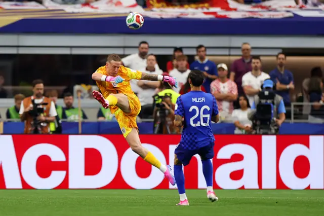Jordan Pickford #1 of England is put under pressure by Petar Musa