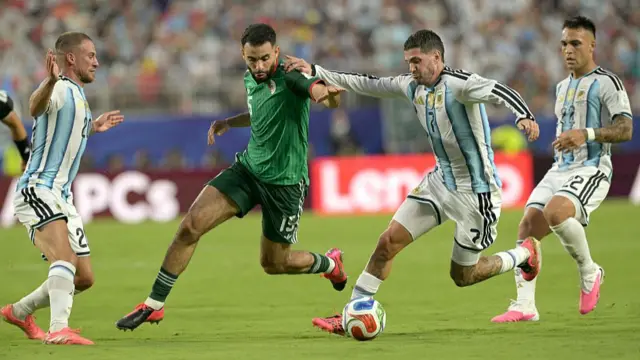 Algeria and Argentina players compete for the ball